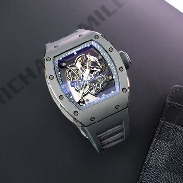 Richard Mille RM-25 with a Black-Case and red strap. Featured in a holiday setting standing on a table with red ribbon and Christmas ornaments.
